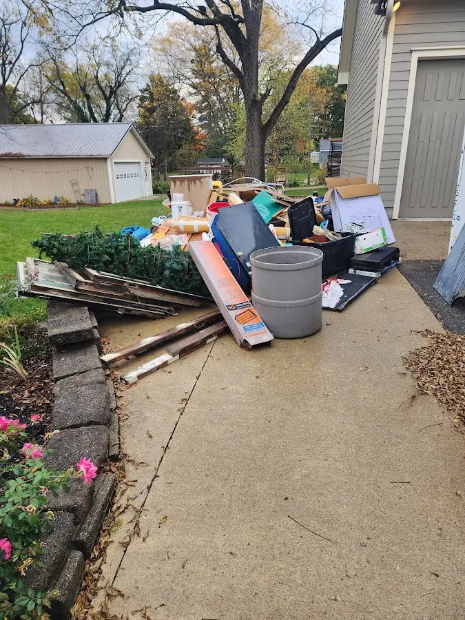 Dumpster being loaded with debris for Estate Cleanout Dumpster Rental in Ridley